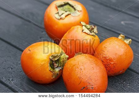 persimmon Fresh ripe persimmon on wooden table fruits on rustic table tropical fruit