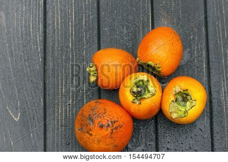 persimmon Fresh ripe persimmon on wooden table fruits on rustic table tropical fruit