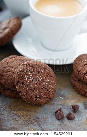 Chocolate cookies with sugar coating and a cup of coffee