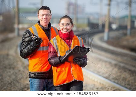Man and a woman railroad workers maintaing railway