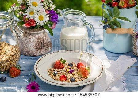 Healthy breakfast with fruit and milk on old wooden table