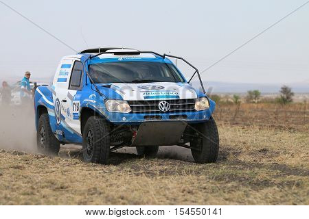 Close-up View Of Speeding Blue And White Vw Amarok Twin Cab Rally Car