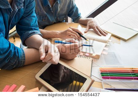Two Asian students studying together at university