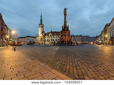 Town hall and Holy Trinity Column in the main square of the old town of Olomouc Czech Republic after sunset.