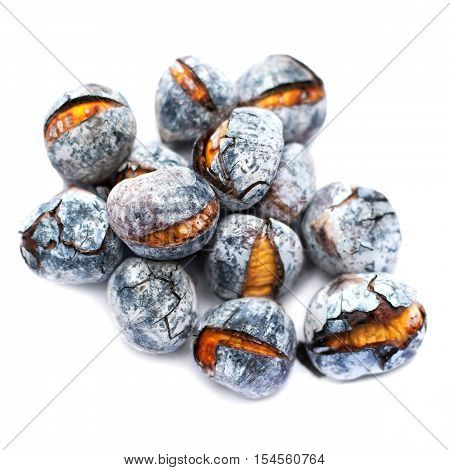 Roasted chestnuts isolated on white background close up. Heap of grilled edible chestnut