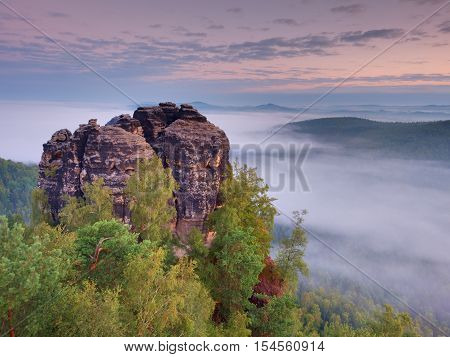 Sharp Sandstone Cliffs Above Deep Misty Valley. Popular Climbers Resor