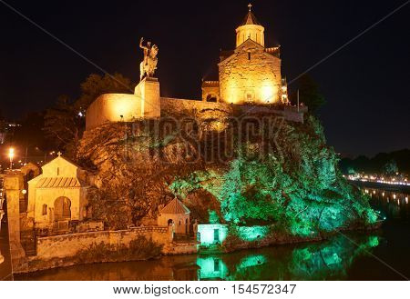 Metekhi orthodox monastery church at sunset and Statue of King Vakhtang Gorgasali. Touristic landmark in Tbilisi Georgia