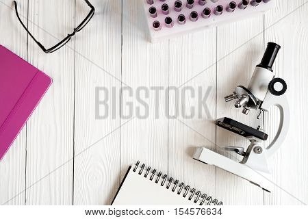 doctor workplace at wooden table with microscope in lab top view no one