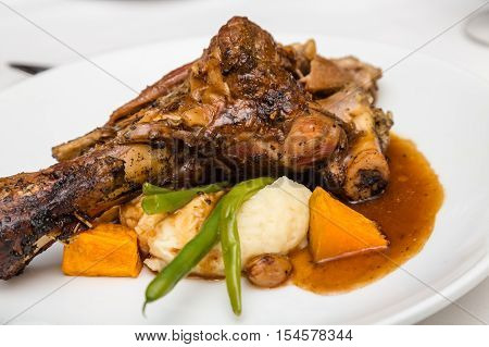 Lamb Shank with Gravy and Vegetables on Plate