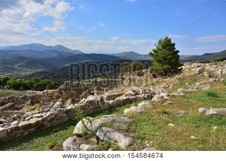 View on the archaeological sites of Mycenae and Tiryns on a beautiful rural greek landscape mountain and agricultural fields