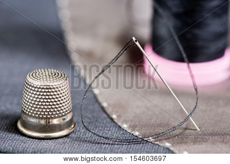 sewing kit on the gray mans jacket
