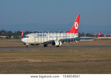 Simferopol Ukraine - September 12 2010: Turkish Airlines Boeing 737NG reversing the engine thrust after the landing on the runway on sunset