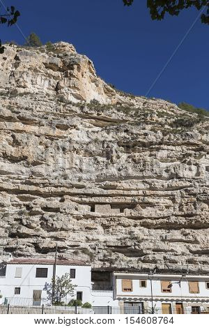 Alcala del Jucar Spain - October 29 2016: Cave House in the mountains of limestone next to the banks of the river Jucar take in Alcala of the Jucar Albacete province Spain
