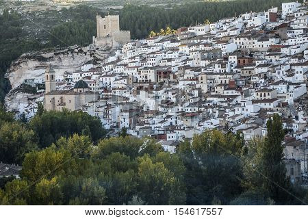 Alcala del Jucar Spain - October 29 2016: Panoramic view of the city on top of limestone mountain is situated Castle of the 12TH century Almohad origin take in Alcala of the Jucar Albacete province Spain