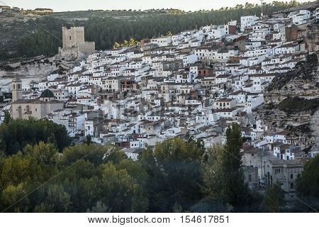 Alcala del Jucar Spain - October 29 2016: Panoramic view of the city on top of limestone mountain is situated Castle of the 12TH century Almohad origin take in Alcala of the Jucar Albacete province Spain