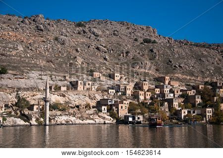 Gaziantep, Turkey - December 08, 2014: Minaret of the mosque in the water in village near Halfeti