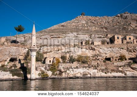 Gaziantep, Turkey - December 08, 2014: Minaret of the mosque in the water in village near Halfeti