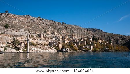 Gaziantep, Turkey - December 08, 2014: Minaret of the mosque in the water in village near Halfeti
