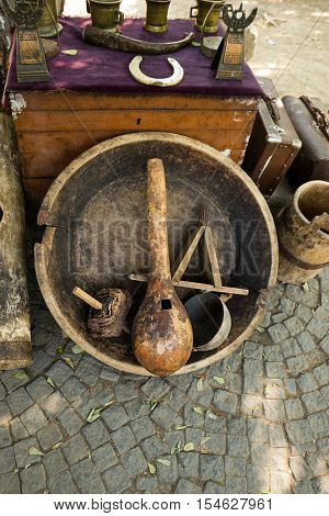 Selling old metal and wooden cookware in bazaar