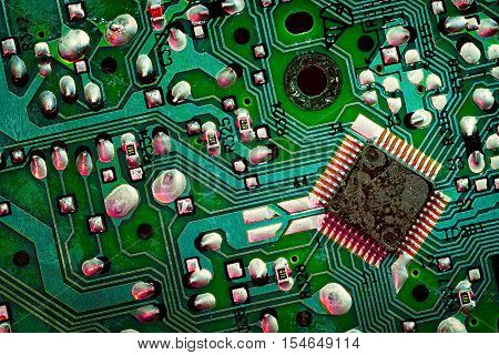 Close up of a printed green computer circuit board. electronics and IT manufacturing and business background