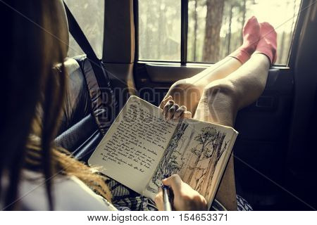 Girl Drawing Pad Road Trip Concept