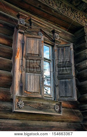 beautiful vintage traditional Russian log house with wooden windows