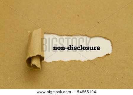 Non-Disclosure word written under torn paper .