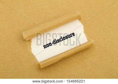 Non-Disclosure word written under torn paper .