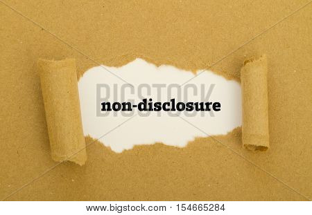 Non-Disclosure word written under torn paper .