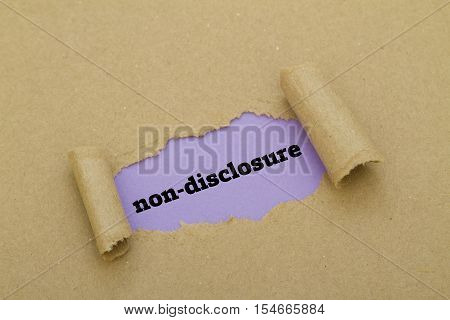 Non-Disclosure word written under torn paper .