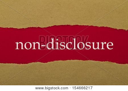 Non-Disclosure word written under torn paper .