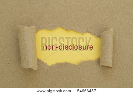 Non-Disclosure word written under torn paper .