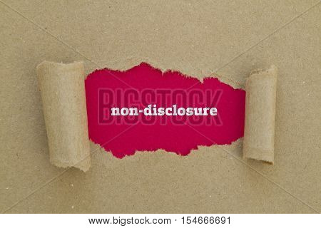 Non-Disclosure word written under torn paper .