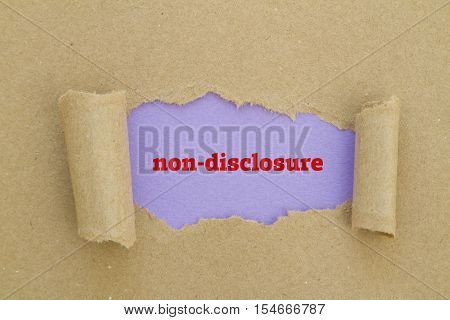 Non-Disclosure word written under torn paper .