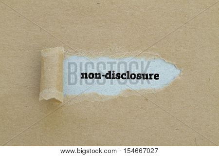 Non-Disclosure word written under torn paper .