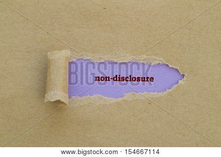 Non-Disclosure word written under torn paper .