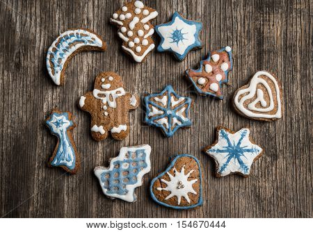 Colorfully Christmas Cookies On Rustic Wooden Background, Gingerman And Tree