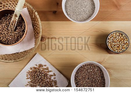 Excellent different cereals on a wooden background.