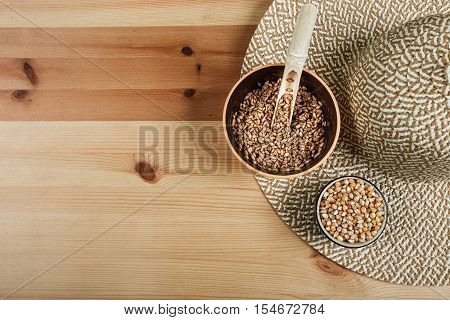 Excellent different cereals on a wooden background.