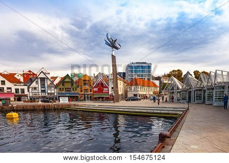 STAVANGER, NORWAY - OCTOBER 10, 2016: People at the quay port with many restaurants and pubs in the city centre of Stavanger. Stavanger is one of most famous cruise travel destinations in Europe.