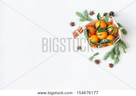 Christmas composition with tangerines fir branches cinnamon sticks anise star. Christmas background. Flat lay top view