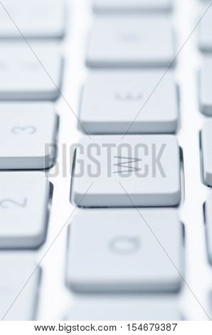 Macro shot of a computer keyboard key with bokeh effect. Selective focus