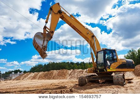 Loader excavator at sandpit during earthmoving works