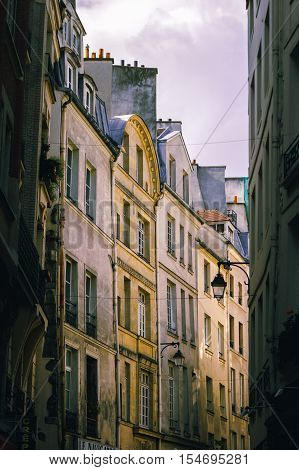 Yellow apartments in narrow alleyway in St Germain Paris.