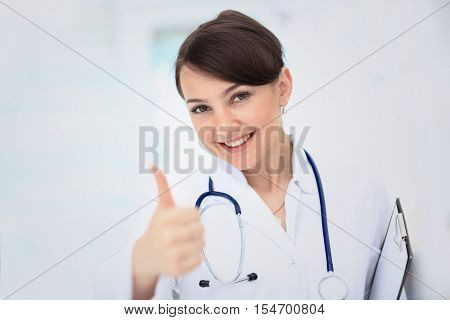 A female doctor shows a sign okay