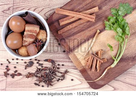 Thai Recipes : Stewed boiled egg with tofu and streaky pork ,call Khai Palo in Thai, take photo with herbs as Chinese star anise ,cinnamon,black pepper,cilantro roots and stems
