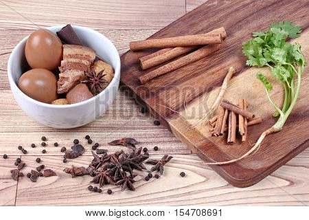 Thai Recipes : Stewed boiled egg with tofu and streaky pork ,call Khai Palo in Thai, take photo with herbs as Chinese star anise ,cinnamon,black pepper,cilantro roots and stems