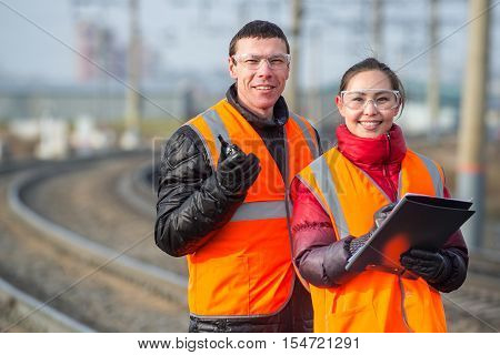 Man and a woman railroad workers maintaing railway