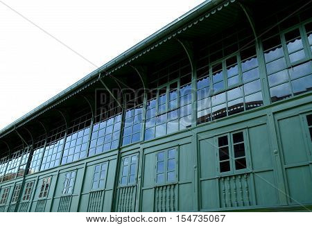 Green and big building with sky reflection