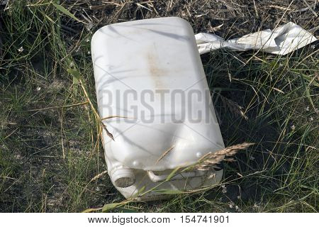 Empty white plastic bottle abandoned on the beach on Mando island in Denmark. Danish national park under UNESCO World Heritage.